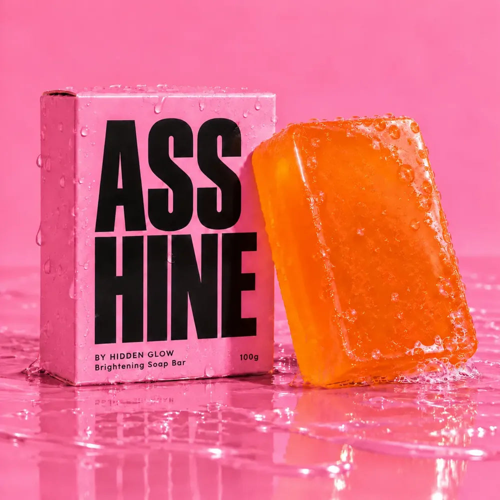 The Asshine brightening soap: a glossy orange bar leaning on its pink box