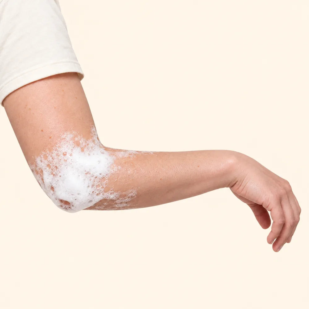 White lather resting on an elbow while it works